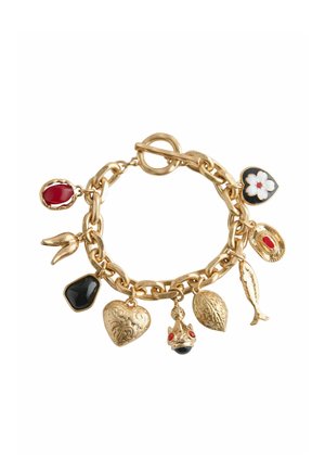 Gold charm bracelet with nine distinct charms including hearts, a fish, red and black stones, and a floral design on a white background.