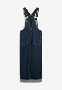 Denim overall dress in dark blue with adjustable straps, front zip closure, and two back pockets. Raw hem with light grey stitching contrast.