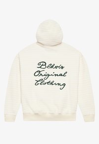 Krém színű kapucnis pulóver, vízszintes fehér csíkokkal, az hátsó részén zöld, ívelt betűkkel "Blkvis Original Clothing" felirattal. Puha anyag, normál illeszkedés.
