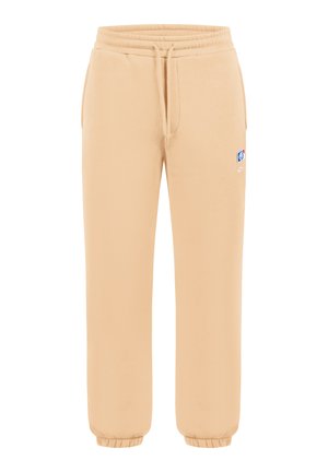 Beige Jogginghose mit elastischem Bund, Kordelzug, Seitentaschen, elastischen Bündchen und einem kleinen mehrfarbigen Logo am oberen Oberschenkel.