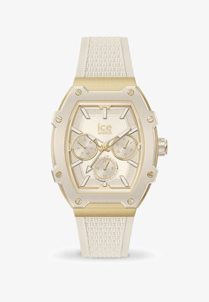 Quarz-Uhr mit einem Gehäuse in Gold- und Silberfarben, ausgestattet mit einem strukturierten weißen Silikonarmband, mehreren Zifferblättern und einer achteckigen Form.