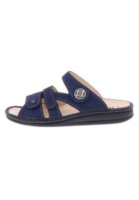 Navy blue slide sandals made of leather, featuring two Velcro straps, a rounded toe, and a textured black rubber sole with stitching details.