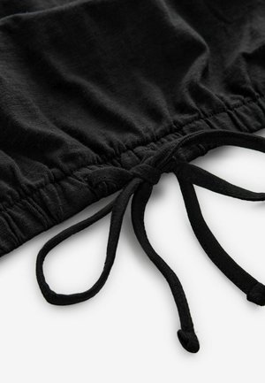 Black fabric with a gathered design featuring drawstrings. Smooth texture with a subtle sheen, no patterns or accents visible.