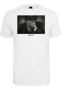 White cotton t-shirt featuring a rectangular black and white graphic of a person covering their face, with the word "trust" in a cursive font below.