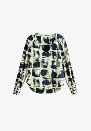 Bluzka z długim rękawem w kremowym kolorze z granatowym i czarnym abstrakcyjnym wzorem pędzla, z głębokim dekoltem V i lekko zaokrąglonym dołem.