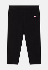 Fekete leggings puha, rugalmas anyagból. Jellemzője egy elasztikus derékpánt és egy kis hímzett logó a bal felső oldalon.