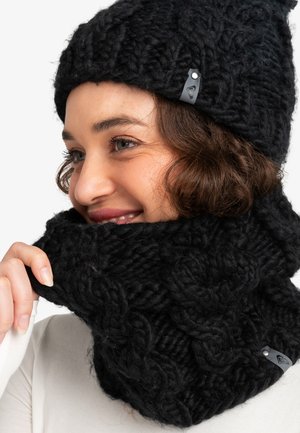Bonnet en tricot noir et col assorti, intégrant un fil texturé épais avec un motif en câble. Comprend une petite étiquette de marque sur le col.