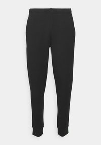 Zwarte sweatpants van zachte stof, met een elastische tailleband, taps toelopende pijpen en ribbels aan de enkel. Geen opmerkelijke patronen of hardware-details aanwezig.
