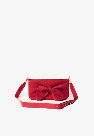 Red handbag featuring a suede bow detail, smooth leather body, and an adjustable strap with gold hardware accents.