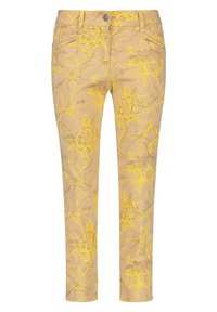 Gul blommönstrade byxor med en ljusbeige bakgrund, slim fit, fem fickor och knappstängning.