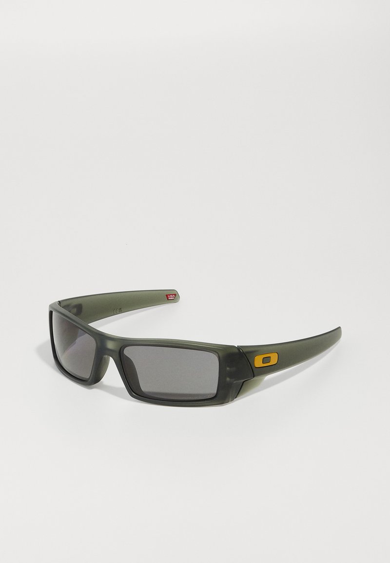 Ochelari de soare din plastic verde cu lentile închise, având accente îndrăznețe de galben și rame dreptunghiulare, textură netedă și laturi curbate.