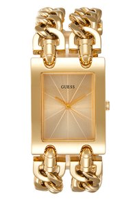 Gold rectangular watch with a sunburst-patterned face, large chain-link band, and a minimalist design. Features the brand "GUESS" on the dial.