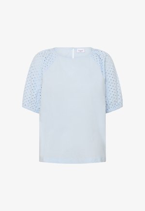 Blouse bleu clair avec manches ballon perforées et encolure ronde, dotée d'une fermeture éclair au dos.