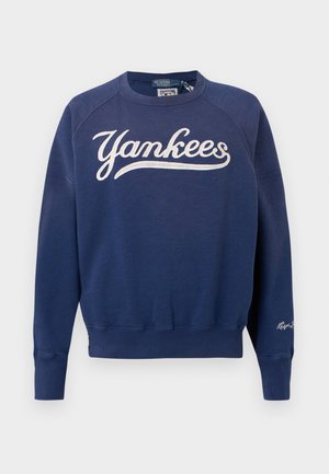 Navy blue crewneck sweatshirt with white "Yankees" script across the chest and small "Ralph Lauren" signature on the left sleeve cuff.