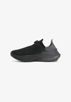 Black athletic shoe with textured fabric upper, cushioned sole, and contrasting purple accent at the heel. Features a secure lacing system.