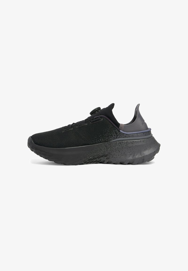 Black athletic shoe with textured fabric upper, cushioned sole, and contrasting purple accent at the heel. Features a secure lacing system.