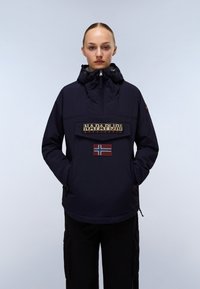 Navy pullover jacket with a high collar, front zipper, large logo patch, and Norwegian flag accent on the chest. Textured fabric.