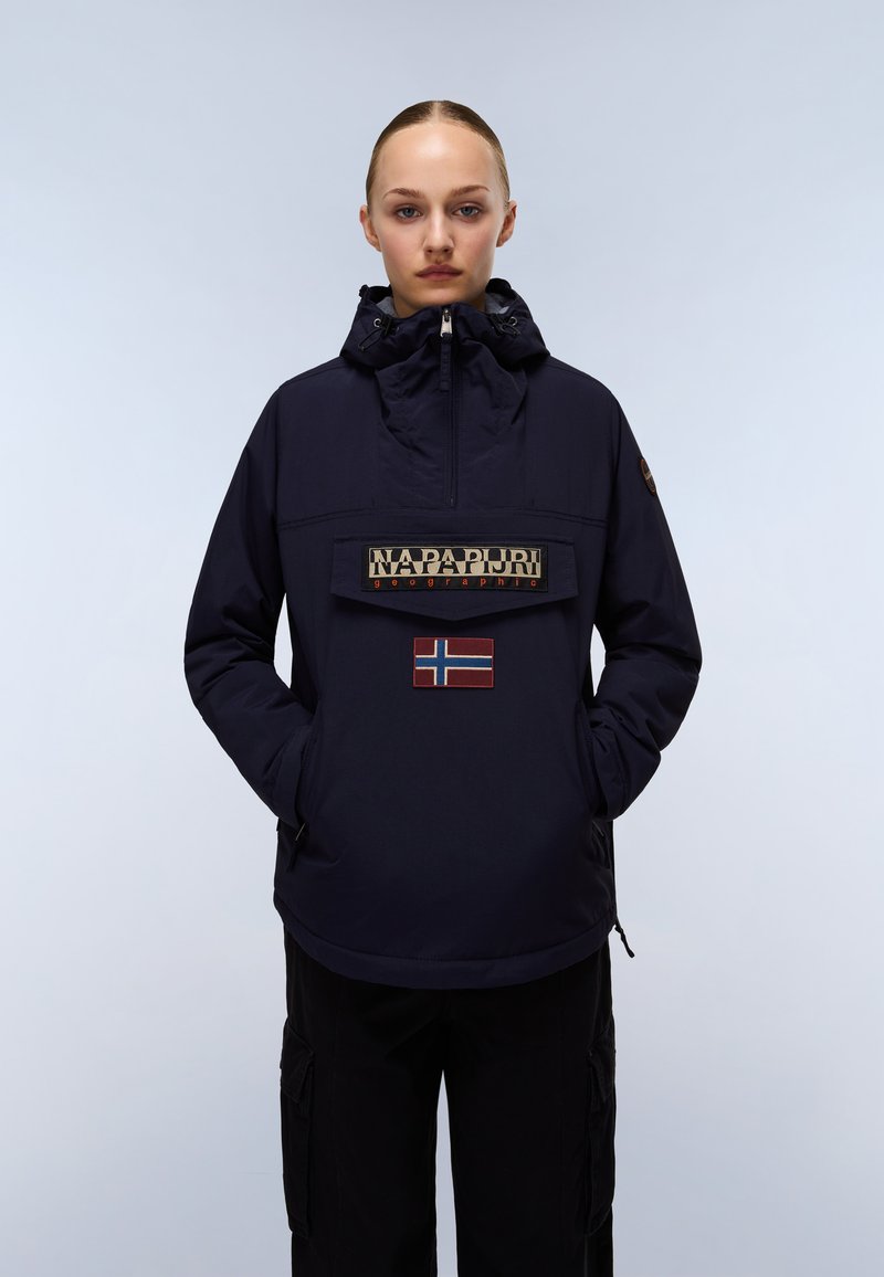 Navy pullover jacket with a high collar, front zipper, large logo patch, and Norwegian flag accent on the chest. Textured fabric.
