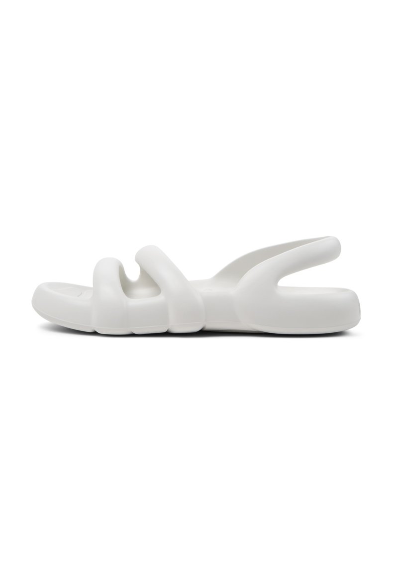 White slip-on sandals with a smooth, flexible plastic material. Features a unique design with three wave-like cutouts on the upper.