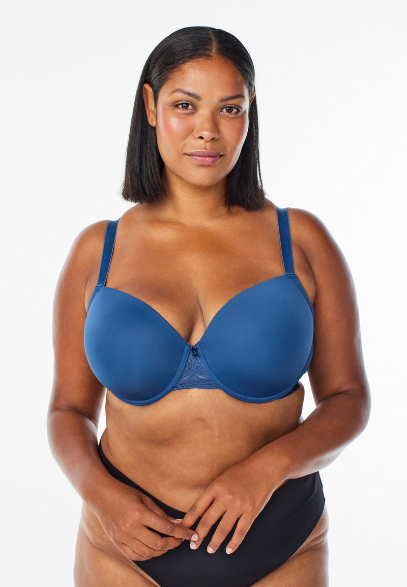 Navy blauwe molded cup bh met kanten accenten in het midden, verstelbare bandjes, een gladde textuur en een naadloos ontwerp voor comfort en ondersteuning.