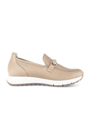 Beige perforated leather slip-on shoe with white sole and metallic buckle detail, designed for casual wear.