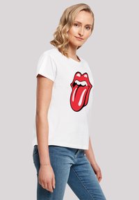 White cotton t-shirt featuring a large red and black lips graphic on the front. Short sleeves and a relaxed fit.