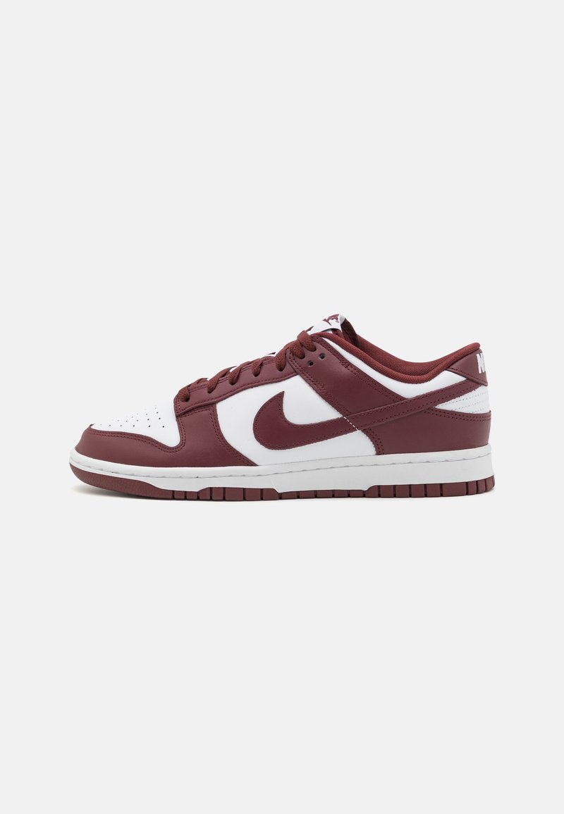 Nike low-top sneakers featuring a maroon and white leather upper, perforated toe, and black rubber outsole with a white midsole.