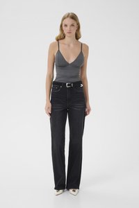 Gray fitted top with thin straps, paired with high-waisted black denim jeans and white pointed-toe heels. Simple, clean design.
