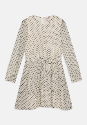 Langermet kjole i kremfarge med svarte prikker, V-hals, samlet liv og utsvingt skjørt. Lett, gjennomsiktig stoff med bånddetalj.