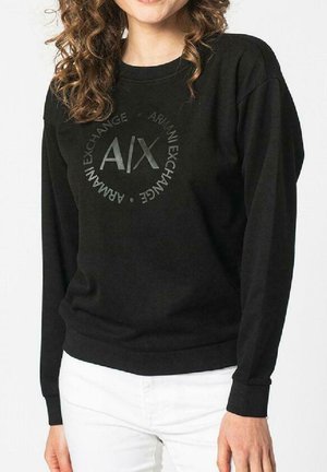 Felpa nera realizzata in tessuto morbido, con un logo rotondo al centro che riporta il testo "Armani Exchange" e polsini e orlo a coste.