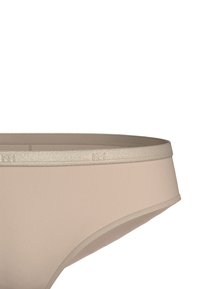 Beige bikiniunderdel med en mjuk textur, elastisk midjeband med en subtil metallisk accent och en klassisk design som är skuren för komfort.