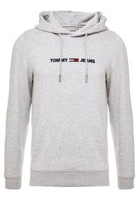 Szara bluza z kapturem, z kieszenią kangurką i wyszywanym logo "TOMMY JEANS" w granatowym i czerwonym kolorze na klatce piersiowej.