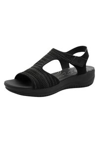 Sandalo nero con punta aperta, superiore in tessuto texturizzato, suola curva e cinturino posteriore regolabile. Presenta una soletta imbottita per il comfort.
