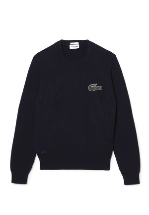Marineblå ribstrikket sweater med rund halsudskæring, lange raglanærmer og broderet grønt krokodillelogo på brystet.