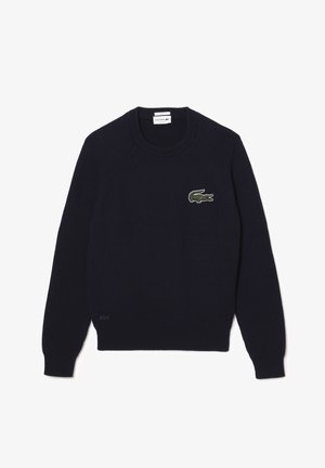 Marineblå ribstrikket sweater med rund halsudskæring, lange raglanærmer og broderet grønt krokodillelogo på brystet.