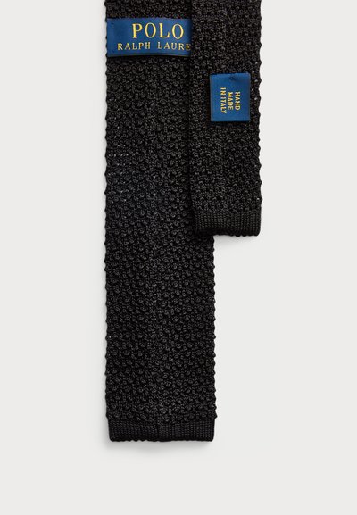 Musthave kootud lips, millel on tekstureeritud muster. Sinine silt "POLO RALPH LAUREN" ja "HAND MADE IN ITALY". Elegantne ja vastupidav disain.