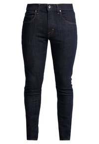 Mörkblå skinny jeans i denim, med klassisk knapplåsning och dragkedja, femfickdesign och kontrasterande sömmar.