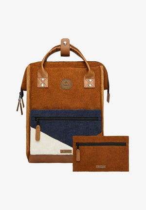 Corduroy backpack in brown, navy, and cream, featuring a leather handle, zippered front pocket, and a small matching pouch.