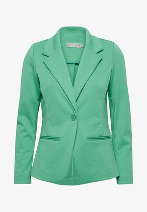 Zöld, szabott zakó, puha, rugalmas anyagból készült. Jellemzői a bevágott hajtóka, az egygombos záródás és két elülső zseb.