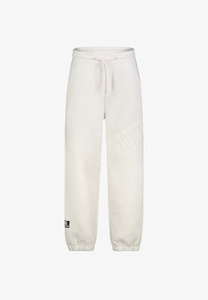 Witte joggingbroek met elastische boorden, trekkoord in de taille, zijzakken, subtiele gegraveerde "SBLM" tekst op het been en een klein zwart label bij de enkel.