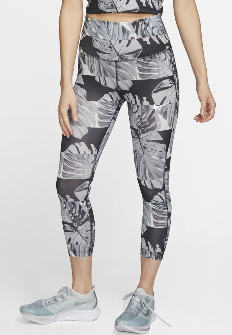 Czarno-szare legginsy z tropikalnym wzorem liści, wykonane z elastycznego materiału, z wysokim stanem i długością do kostek.