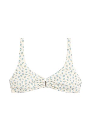 Top de bikini blanco con pequeño estampado floral azul, tirantes finos y detalle de nudo en el centro.