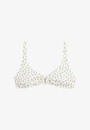 Top de bikini blanco con pequeño estampado floral azul, tirantes finos y detalle de nudo en el centro.