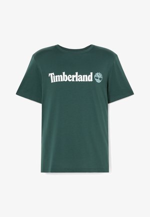 Ciemnozielona koszulka z okrągłym dekoltem i krótkim rękawem z białym napisem "Timberland" oraz logo drzewa na klatce piersiowej.