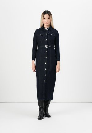 Denim shirt dress in dark navy, featuring long sleeves, two chest pockets, front buttons, a belted waist, and a straight fit.