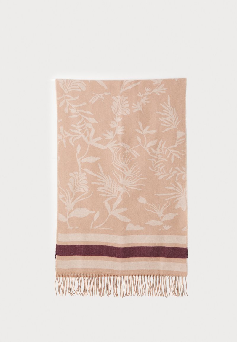 Floral-patterned blanket in soft peach with white botanical designs. Features dark maroon and cream striped accents, finished with fringing.