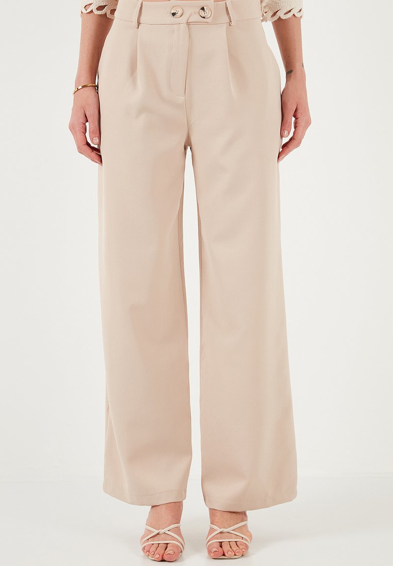 Beige wide-leg trousers with a high waist, double-button closure, and pleated front. Made from a smooth fabric, featuring a tailored design.