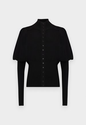 Černý pletený svetr s vysokým límcem, krátkými nabíranými rukávy a dlouhými žebrovanými manžetami, s plným řadou knoflíků na přední straně.