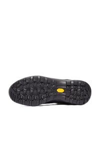 Svart gummisul med ett strukturerat mönster. Har en framträdande gul Vibram-logotyp i mitten, vilket förbättrar grepp och hållbarhet.