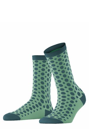 Groene sokken met donkergroene stippen, halverwege de kuit, met ribbelboord en versterkte teen. Gemaakt van een gladde, rekbare stof.